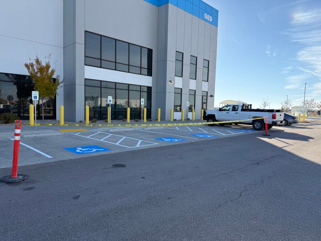 ADA accessible parking space pavement markings with blue striping and access aisle