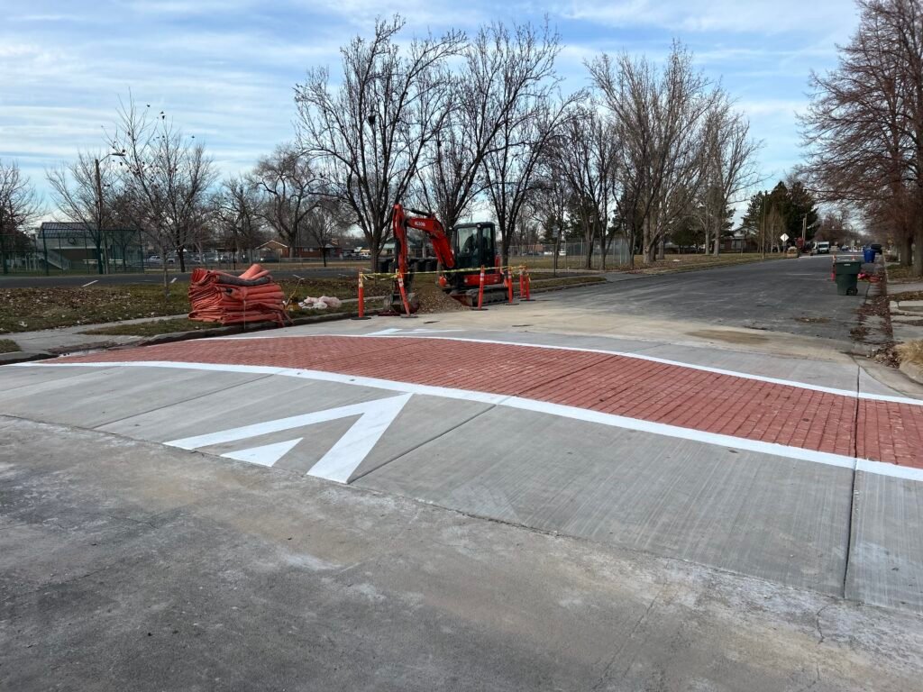 Specialty pedestrian crossing pavement marking with directional lines
